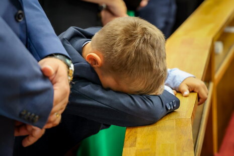 Znudené dieťa v kostole Pre deti je náročné vydržať v pokoji absolvovať celú omšu